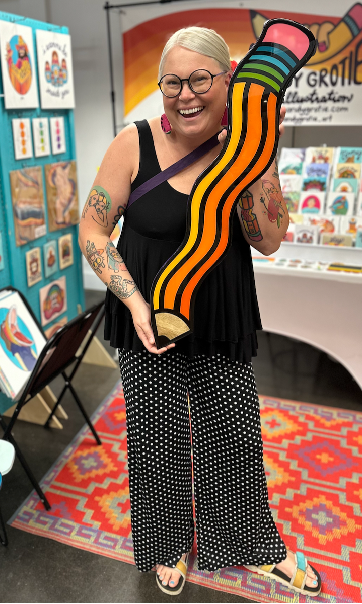 person holding a colorful pencil piece of art